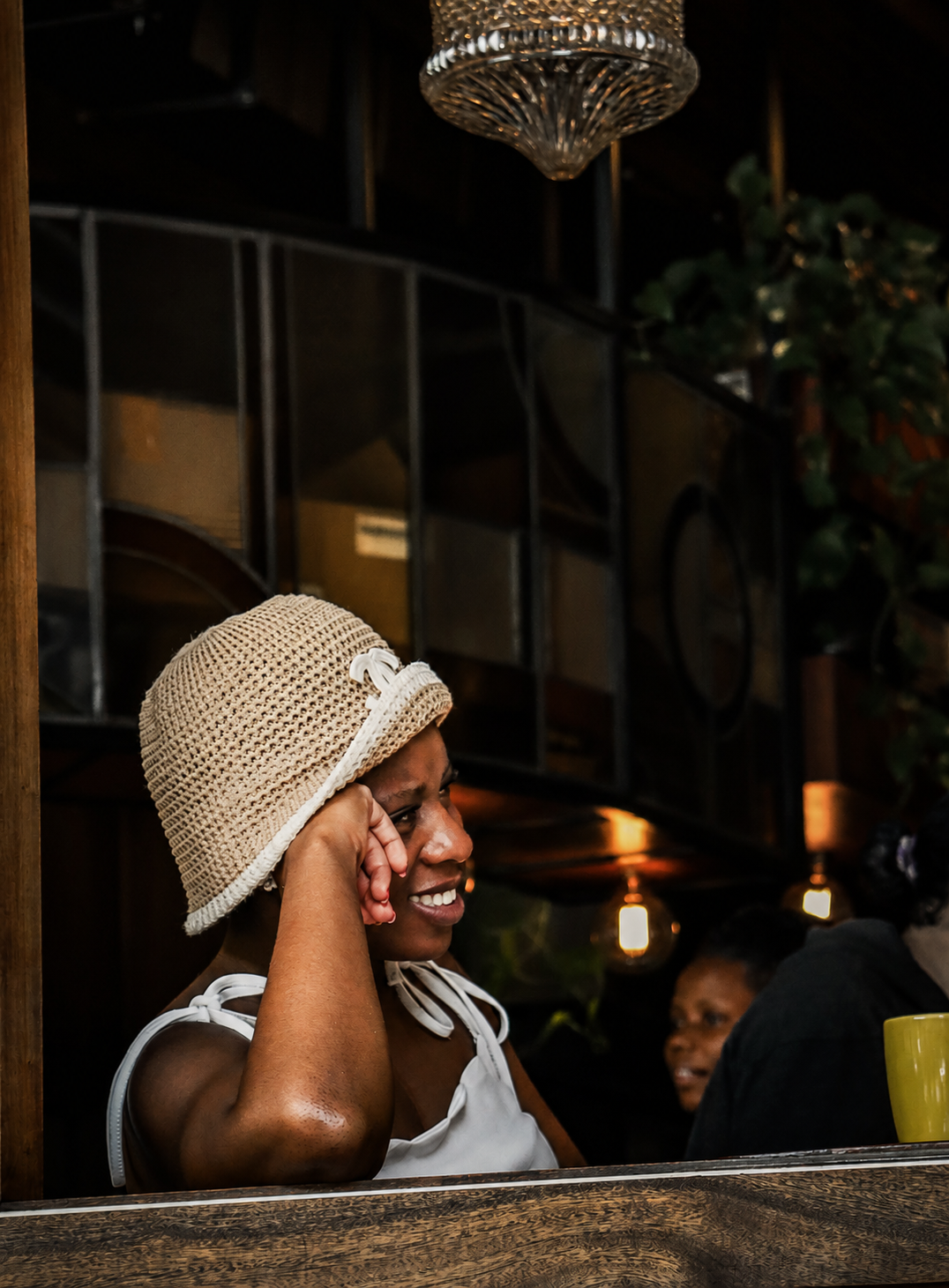 Woman laughing at bar, candid social moment
